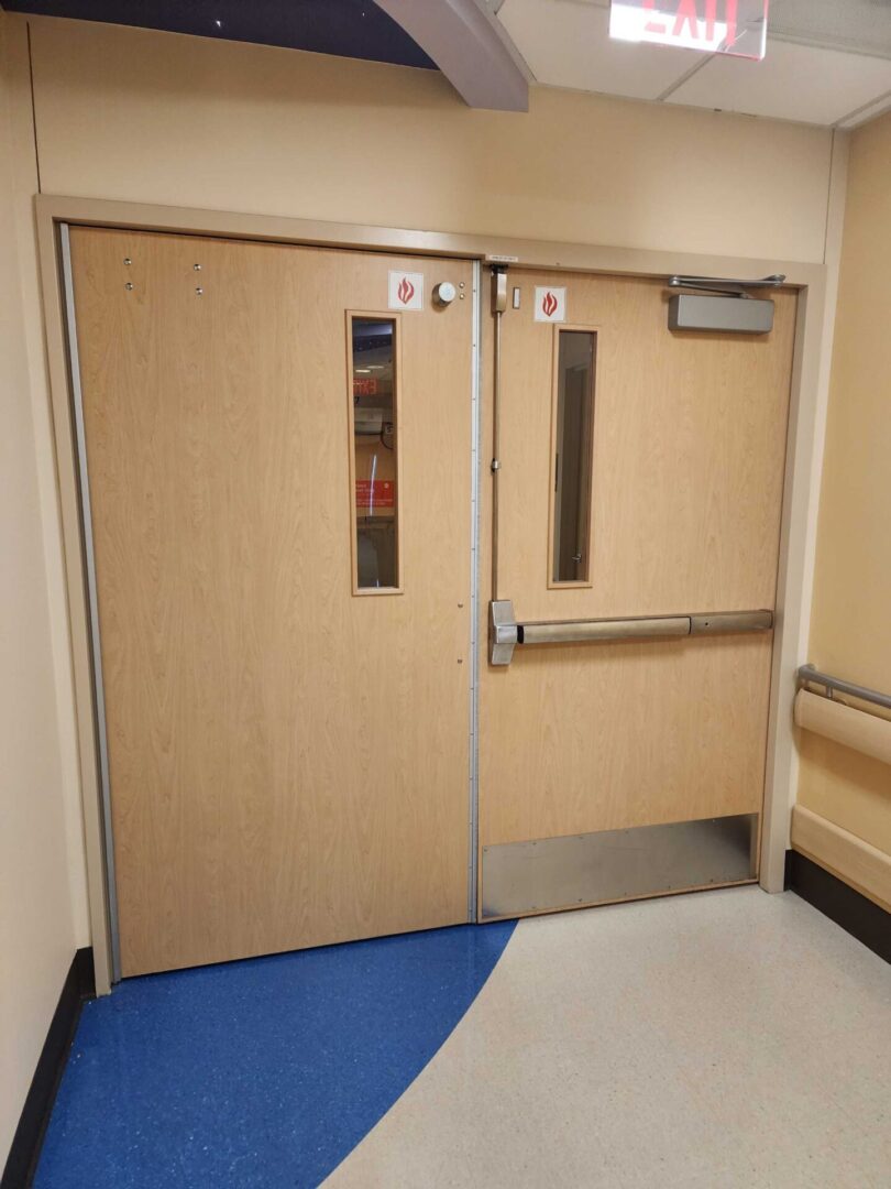 A pair of doors in the hallway of an office building.